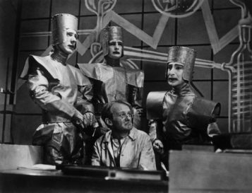 11 Feb 1938, Haringay, Outer London, London, England, UK --- A scene of a television production of , or Rossum's Universal Robots, by Czech playwright Karel Capek, which introduced the term "Robot" into many of the world's languages. (l to r) Connaught Stanleigh, Derek Bond, Larry Silverstone and front, Evan John --- Image by © BBC/Corbis