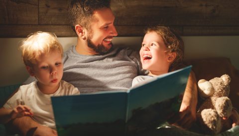 evening family reading. father reads children . book before going to bed