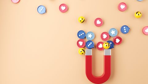 Social media marketing concept. Attracting (emoji, like, love, star, comment icon) with a huge magnet.